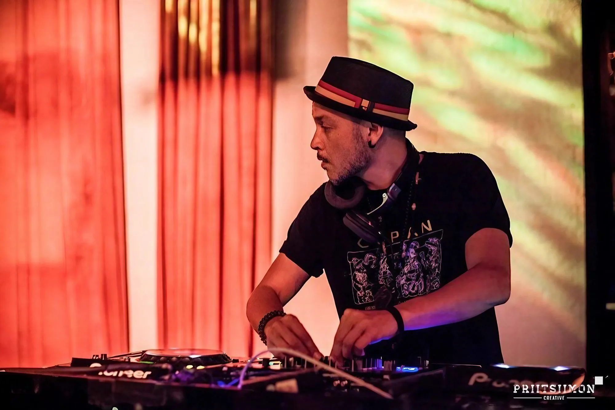 DJ CMAN live on stage with projected visuals — Sydney DJ