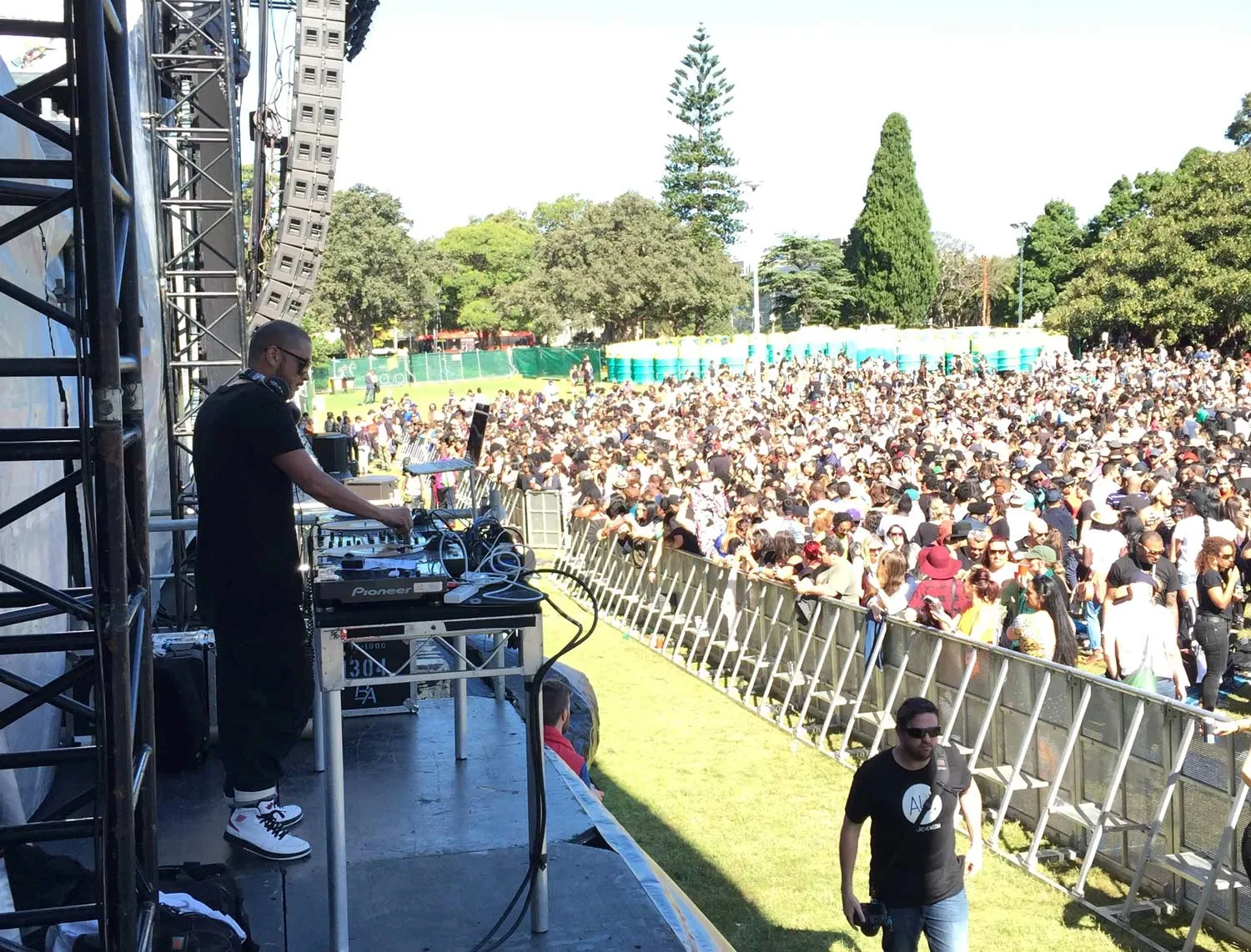 DJ CMAN performing on the Soulfest Sydney stage in 2014, with a large daytime crowd gathered behind the barrier