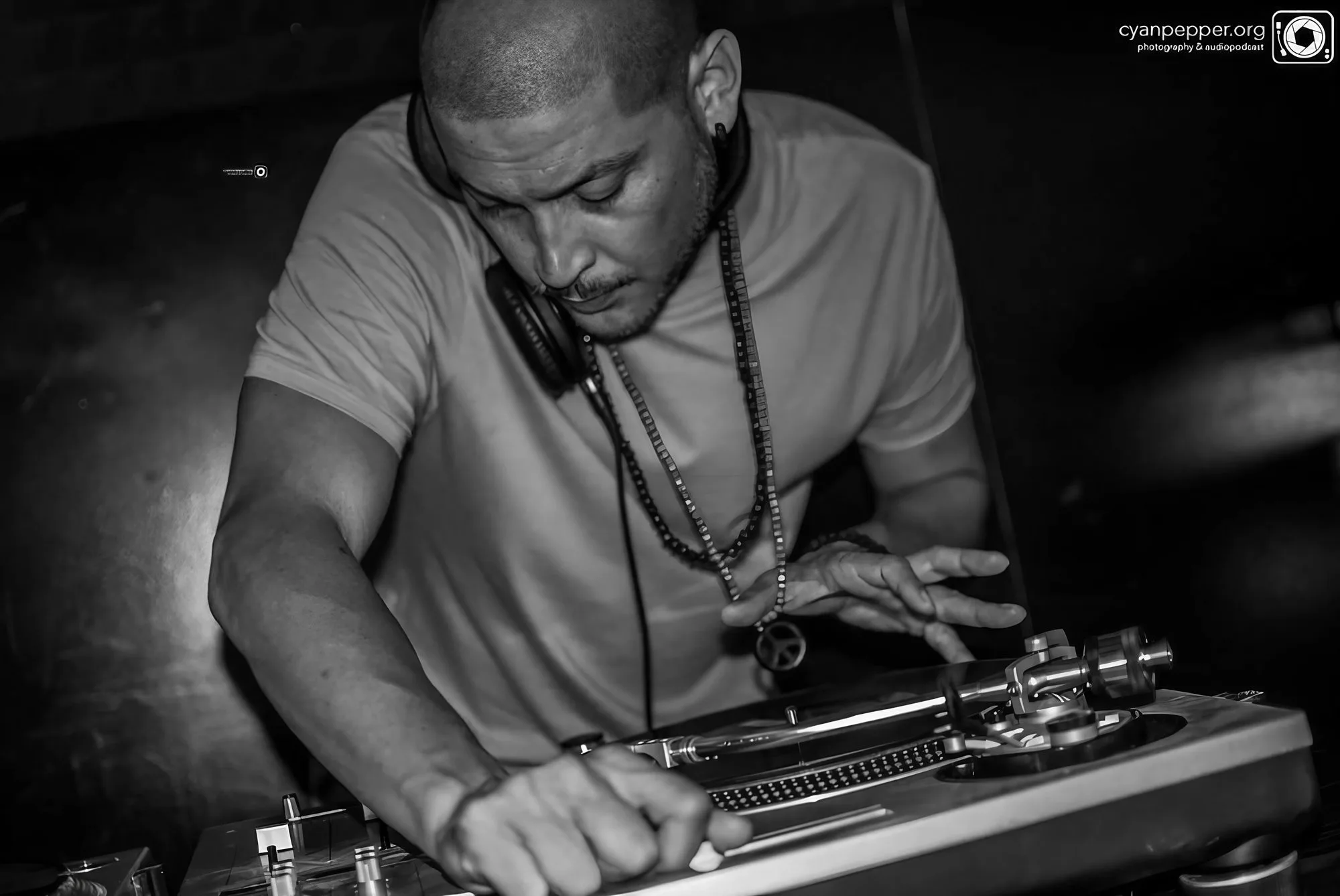 DJ CMAN cueing a record on vinyl, black and white — Sydney hip-hop and funk DJ